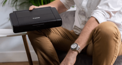 Canon MAXIFY BX110 being put into a backpack